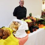 man serving at a buffet table